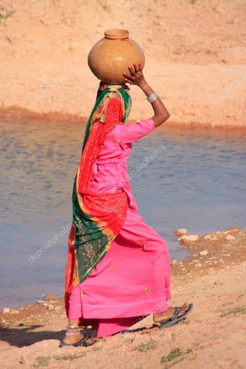 depositphotos_49607769-stock-photo-local-woman-carrying-jar-with.jpg