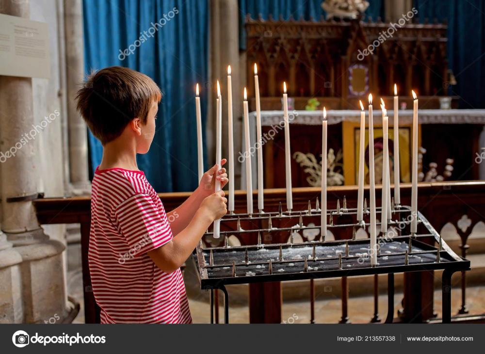 depositphotos_213557338-stock-photo-little-boy-prays-puts-candle.jpg